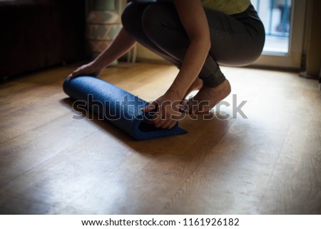 Mid adult woman finishing exercise at home.