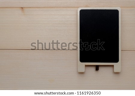 Top view and close up: A small empty blackboard for your text on wooden background