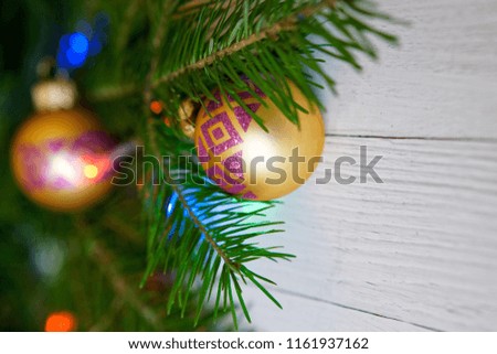 New Year tree, decorated with beautiful balls and colorful lights, on a light background. Congratulations on the New Year.                            