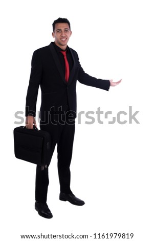 Full length shot of a businessman wears a black suit, holding a bag and doing welcome sign, isolated on white background