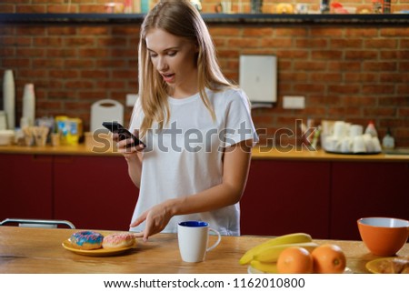 Beautiful woman takes picture of her breakfast