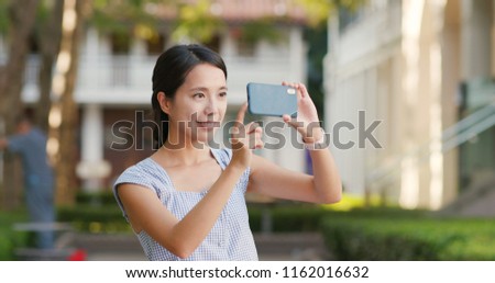 Woman use of mobile phone for take photo at outdoor