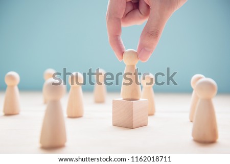 Successful team leader, Businessman hand choose people standing out from the crowd. Royalty-Free Stock Photo #1162018711