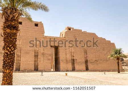 Entrance of Karnak Temple in Luxor. Walls with carvings of gods and heiroglyphs written in Ancient Egypt language