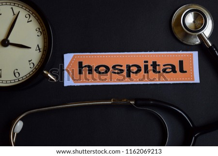 Hospital on the print paper with Healthcare Concept Inspiration. alarm clock, Black stethoscope.