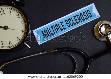 Multiple Sclerosis on the print paper with Healthcare Concept Inspiration. alarm clock, Black stethoscope.