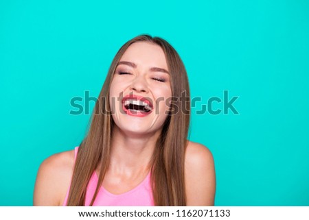 Portrait of young straight-haired gorgeous nice cute attractive perfect girl laughing out loudly. Isolated over bright vivid turquoise teal background