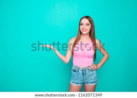 Attractive magnificent nice cute pretty glamorous beautiful straight-haired smiling girl showing product on palm. Copy empty blank space. Isolated over bright vivid turquoise teal background