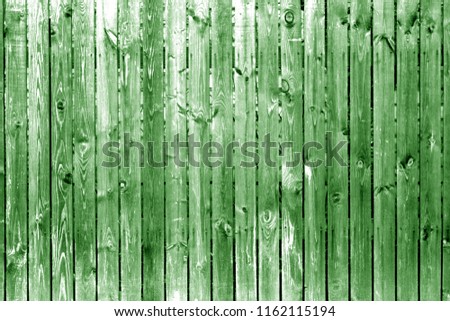 Old wooden fence in green color. Abstract background and texture for design.