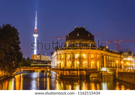 Illuminated Night view of Bode Museum in  Berlin with Berliner Fernsehturm TV tower in the background