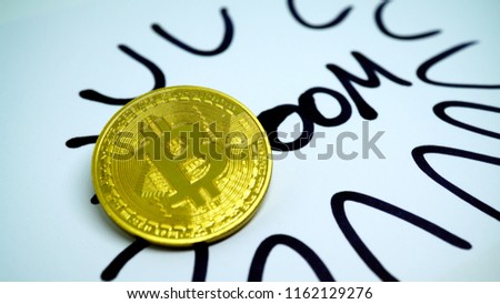 Written Boom with golden Bitcoin coin as a B. Conceptual photo for profit