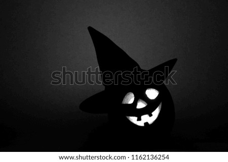 Halloween pumpkin, silhouette of funny face on black background