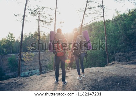 Tourist traveler healthy lifestyle extreme sport freedom panorama trekking hiking concept. Back behind rear view photo of two dreamy careless excited people holding hands watching sunrise green wood