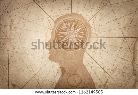 Human head and compass. The concept on the topic of navigation, psychology, morality, etc. Royalty-Free Stock Photo #1162149505