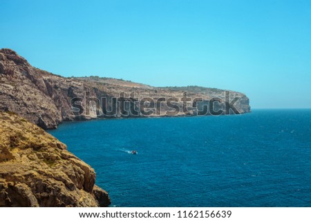 Rocky landscape, Ocean and boat in Malta