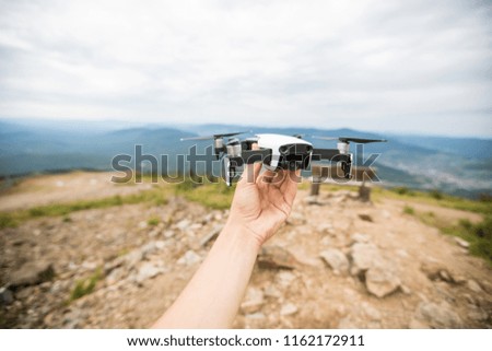 Drone  takes off from man hand in park. Technology concept blogger photographer. Outdoors