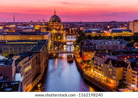 Panoromic  aerial view of Berlin skyline with famous TV tower and Spree river in beautiful post sunset twilight during blue hour at dusk with dramatic  colorful clouds , central Berlin Mitte, Germany Royalty-Free Stock Photo #1162198240