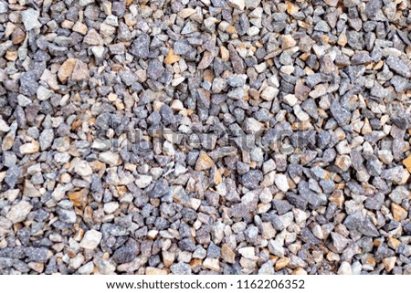 Surface of grey gravel on the ground