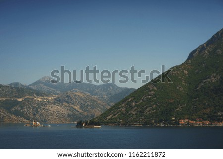 Boko-kotorska bay in Montenegro. Epic view of the island of Saint George Island and the Roman Catholic Church of Our Lady of the Rocks Church. Landscape, a trip to Montenegro, Perast and Kotor.