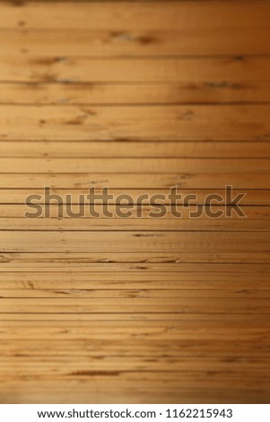 Close up view of an exterior hall wooden ceiling. Abstract design with clear brown parallel planks. Bright textured surface with dark lines. Geometric picture with natural elements. 