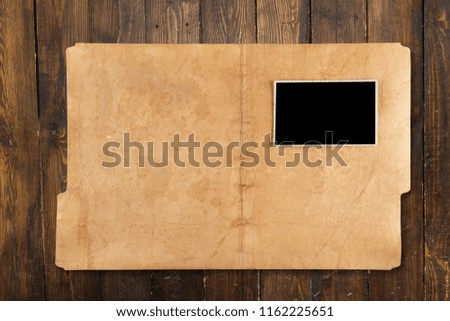 Blank photo on business folder on wooden table