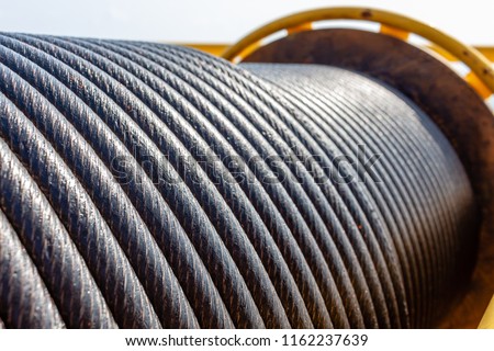Wire rope sling or cable sling on crane reel drum  or winch roll of crane the lifting machine in heavy industrial Royalty-Free Stock Photo #1162237639
