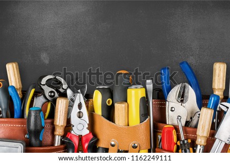 Tool belt with tools on wooden background Royalty-Free Stock Photo #1162249111