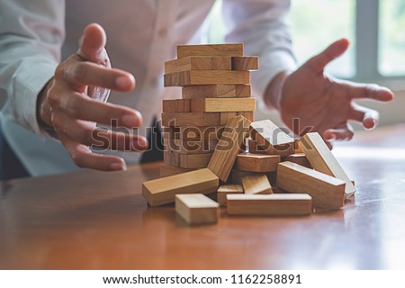 Problem Solving Business can't stop effect of dominoes continuous toppled with business team feeling sad and stress in office background. Failure Business Concept. Royalty-Free Stock Photo #1162258891