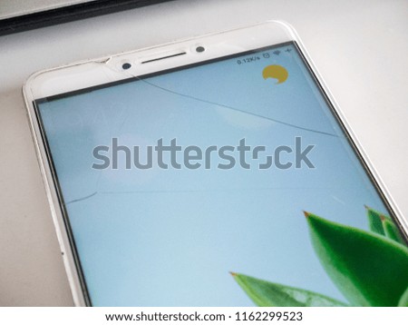 Smartphone with Cracked Tempered Glass Screen