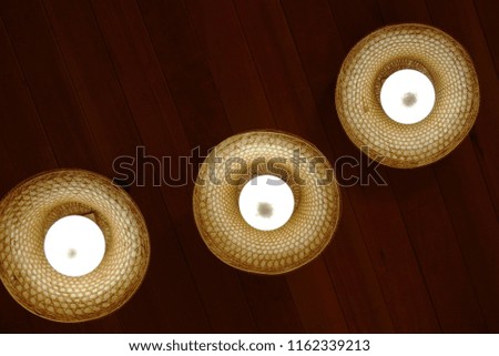 A group of hanging lights with shallow depth of field with wooden background.