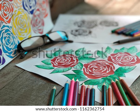 Colorful rose bouquet flower by color pencil on white paper,eyes glasses and colored pencil on wooden board.Hand drawing flower illustration,decorative series with pen line,with dark tone,rural style.