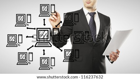 young  businessman drawing computer network