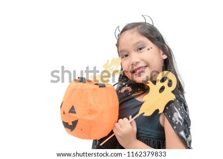 funny child girl in witch costume for Halloween playing paper ghost isolated on white background
