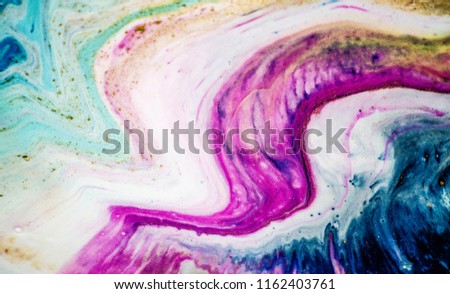 Magic unique painting. Mixed paints,  gold metallic paint. Paper marbling is a method of aqueous surface design, which can produce patterns similar to smooth marble or other kinds of stone.