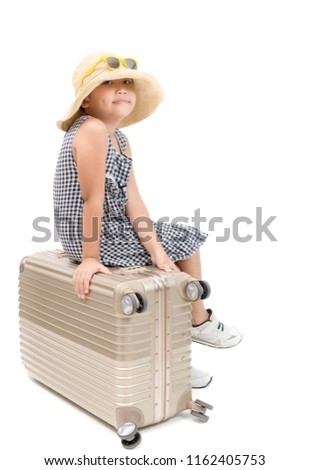 Happy asian traveler sit on baggage isolated on white background, travel and vacation concept