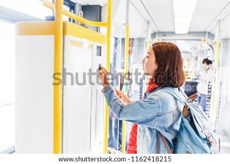 Woman buying ticket in tram or bus. public transport concept