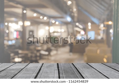 wood table top and Abstract Blurred restaurant and cafe interior. Can be used for display or montage your products.