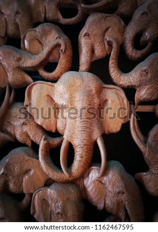 Sculptured elephant figure wood piece. Traditional art of Thailand. Asia elephant. Wood texture. Close up shot.