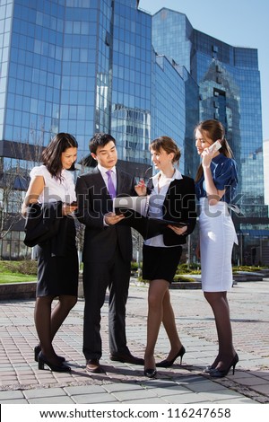  Group of business people meeting outdoor in front of office building