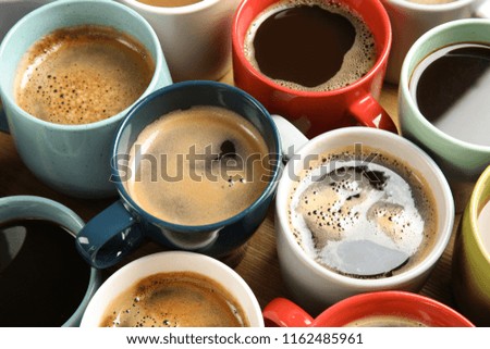 Cups of fresh aromatic coffee on wooden table. Food photography