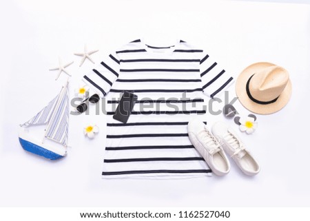 Blue clothes collage on white with sunglasses,starfish, , hat, shoes ,purse, frangipani ,jeans on flat lay, top view

