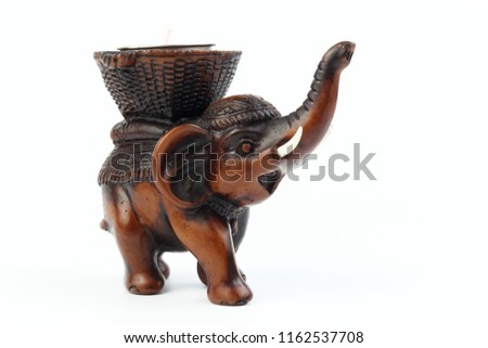 Brown elephant made of resin like wood carving with white ivory. Stand on white background, Isolated, Art Model Thai Crafts, For decoration Like in the spa.
