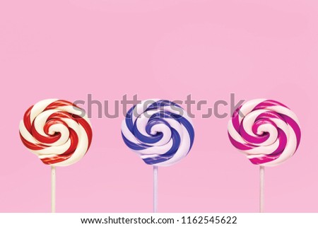 three candies with pink background