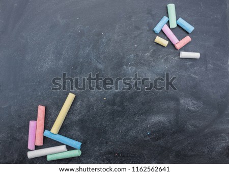 Dark board with colored pencils for drawing. space for copying. draw chalk on a blackboard. preparation for school.