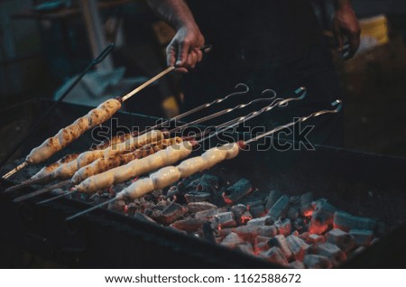 Georgian cuisine. The meat is wrapped in a dough on a grill. Grilled meat in dough. food festival