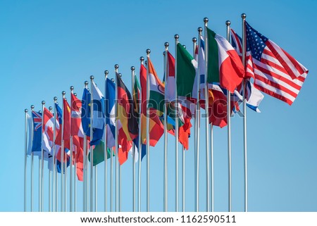 national flags of various countries flying in the wind Royalty-Free Stock Photo #1162590511