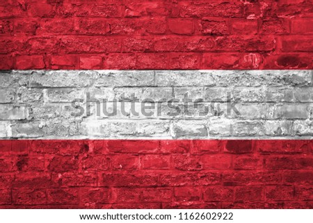 Flag of Austria over an old brick wall background, surface