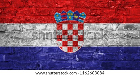 Flag of Croatia over an old brick wall background, surface. Croatian national symbol