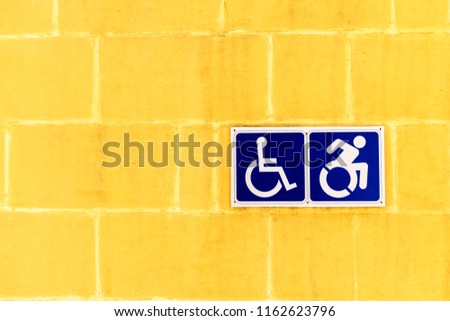 Disabled sign on a yellow tiles wall