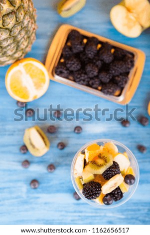 Top view of summer delicious desert. Bowl full of delicious fruits